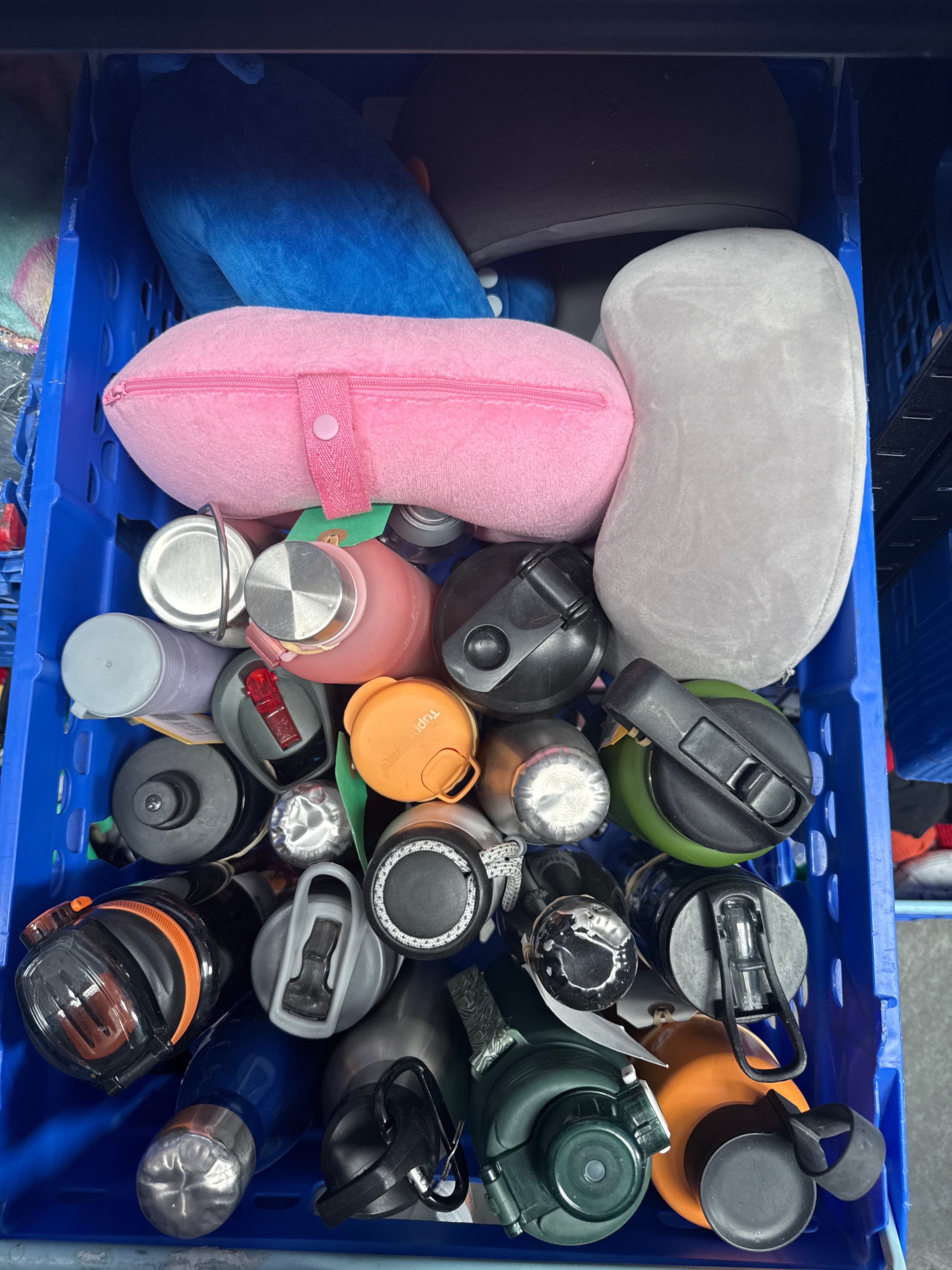Assortment of neck pillows and bottles